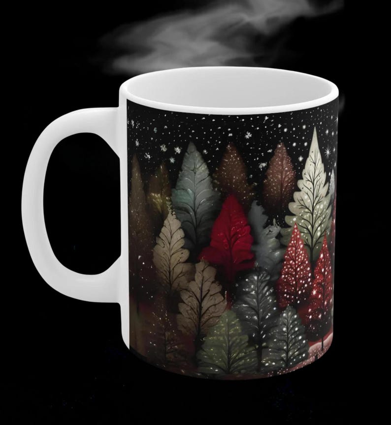 May include: White ceramic mug with a black background and a design of a forest of trees with different colors, including red, green, and brown. The trees are silhouetted against a dark background with white snowflakes.