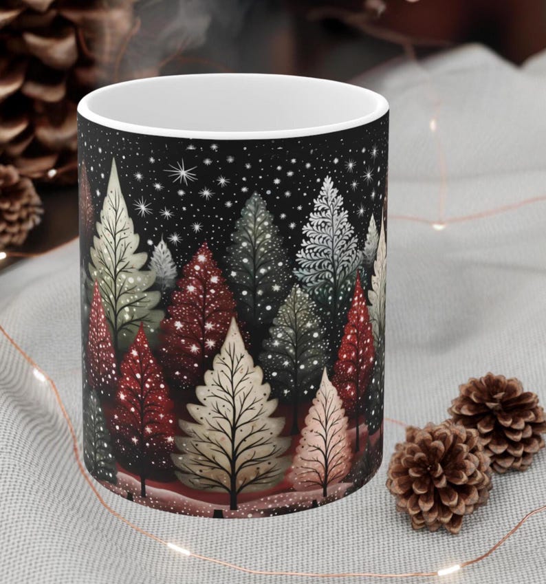 May include: White ceramic mug with a black background and a winter forest scene. The trees are decorated with red, green, and white lights and snow. The mug is perfect for hot beverages.