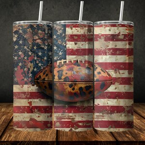 May include: Three stainless steel tumblers featuring a distressed American flag design and a football with a leopard print design.