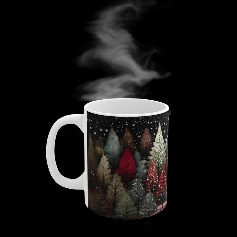 May include: White ceramic mug with a black and white illustration of a snowy forest with colorful trees. The mug has a handle and is filled with steam.