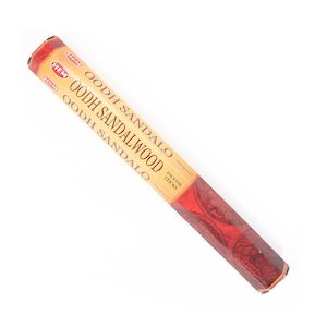 May include: A package of HEM Oodh Sandalwood incense sticks. The packaging is primarily tan with red accents and features the product name in large, bold letters. The bottom of the package has a red floral design.