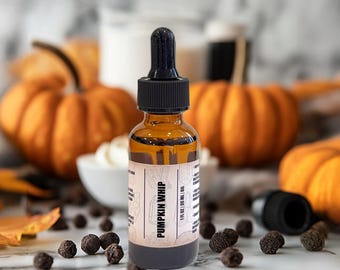 May include: An amber glass dropper bottle with a black cap and a label that reads PUMPKIN WHIP, 1 FL OZ | 30 ML | OIL. The bottle contains a golden liquid and is positioned upright, featuring a clear glass dropper top for dispensing the contents.