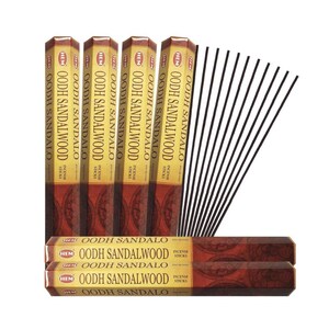 May include: An assortment of HEM Oodh Sandalwood incense sticks. The image shows several boxes of incense sticks, with the brand name and product name printed on the packaging. A bundle of black incense sticks is also visible.