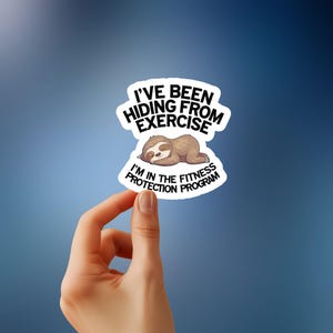 May include: A white sticker with black text that reads "I've been hiding from exercise I'm in the fitness protection program". A cartoon sloth is sleeping on the sticker.