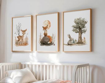 May include: Three framed watercolor illustrations of woodland animals. The first shows a fawn standing in a forest clearing. The second shows a fox sitting on a rock with a full moon behind it. The third shows a rabbit sitting under a tree.