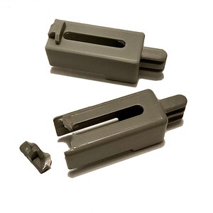 May include: Two gray plastic drawer slide clips. One clip is broken and the broken piece is visible next to the clip.