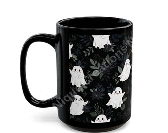 May include: A black ceramic mug featuring a repeating pattern of small white ghosts with pink cheeks interspersed with dark grey and black botanical foliage. The text NiqueCreations is visible in a light grey font across the center of the mug.