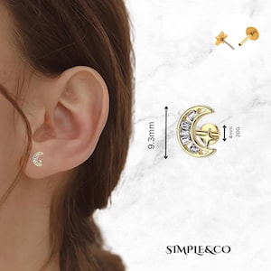 May include: Gold crescent moon earring with clear cubic zirconia stones. The earring is 9.3 mm tall and 4 mm wide. The earring is 20 gauge.