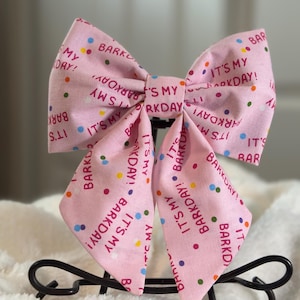May include: Pink bow with a white polka dot pattern and the text "It's My Barkday!" repeated throughout.