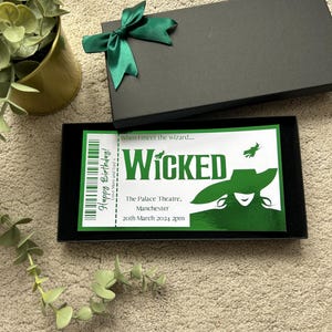 May include: A green and black ticket for the musical Wicked at the Palace Theatre in Manchester on March 20, 2024 at 2pm. The ticket has the text "When I meet the wizard..." and a silhouette of the Wicked Witch of the West.