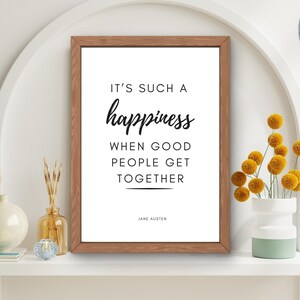 May include: A printable quote in a brown frame on a white shelf. The quote reads "It's such a happiness when good people get together."  The quote is attributed to Jane Austen.