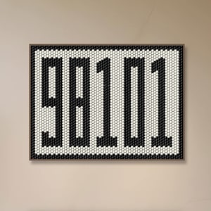May include: A black and white mosaic wall art featuring the number "98101" in a modern, geometric design. The art is displayed above a fireplace in a contemporary living room.