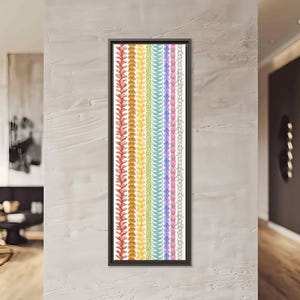 May include: A framed vertical artwork featuring colorful botanical illustrations. The artwork displays a series of vertical bands with various plant-like designs in shades of red, orange, yellow, green, blue, and pink. The frame is black.