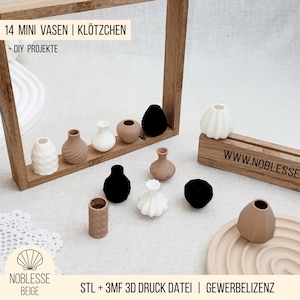 May include: A collection of fourteen miniature vases in various shapes and colors, including white, beige, and black. The vases are displayed on a wooden frame and a wooden stand. The text "14 MINI VASES | BLOCKS + DIY PROJECTS" is visible.