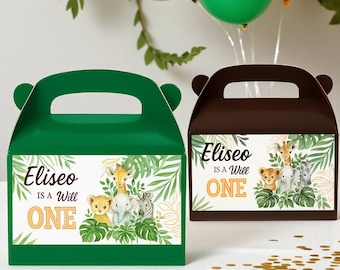 May include: Two party favor boxes, one green and one brown, with handles and animal illustrations. The boxes feature the text "Eliseo is a Will ONE" and jungle-themed graphics, perfect for a first birthday celebration.