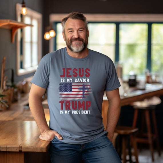 Faith meets politics in our 'Jesus Is My Savior, Trump Is My President' tee with distressed flag design!