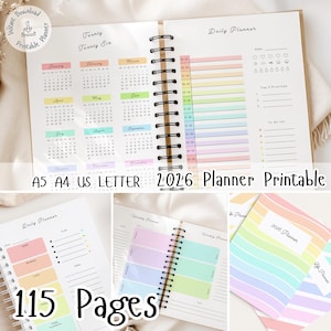 May include: A spiral-bound 2026 planner with colorful pages. The planner includes a calendar, daily planner pages, and weekly planner pages. Text on the planner reads "A5 A4 US LETTER 2026 Planner Printable" and "115 Pages."
