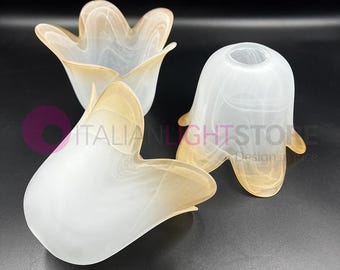 May include: Three white glass lampshades with a brown swirl design. The lampshades are shaped like a flower with five petals.