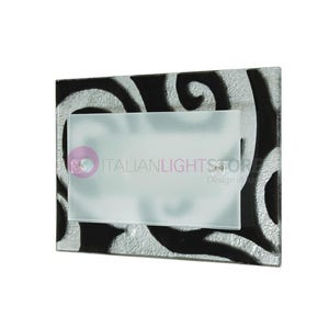 May include: A black and white glass wall sconce with a frosted glass shade. The sconce features a swirling pattern and the text "ITALIANLIGHTSTORE Design in nature".