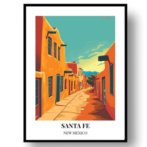 May include: A framed art print depicting a street scene in Santa Fe, New Mexico. The illustration features orange adobe buildings lining a narrow path under a teal sky. The text SANTA FE NEW MEXICO is printed in black at the bottom of the white border.