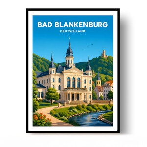 May include: A framed travel poster featuring a light-coloured building with a central tower and dark roof, set against green hills and a blue sky. A winding path and a blue stream are in the foreground. The text reads BAD BLANKENBURG DEUTSCHLAND.