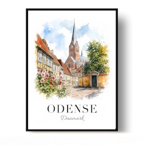 May include: A watercolor art print featuring a street scene in Odense, Denmark, with half-timbered houses, pink flowers, a tall church spire, and a cobblestone path. The text ODENSE Danmark is printed in black at the bottom of the white framed image.