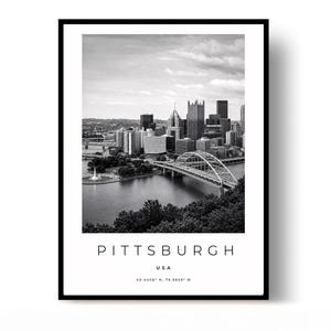 May include: A black and white framed wall art print featuring the Pittsburgh skyline, a river, and a bridge. Below the image, the text reads PITTSBURGH, USA, and the coordinates 40.4406° N, 79.9959° W in a clean, sans-serif font.