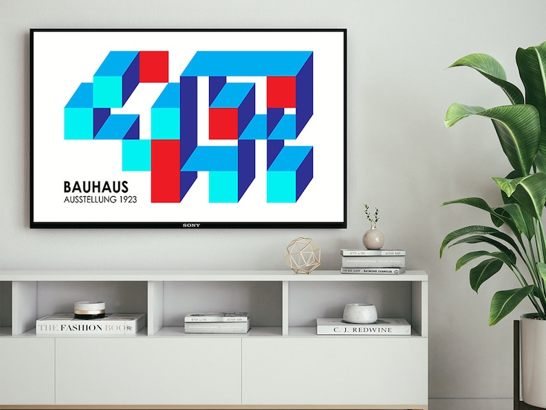 May include: A television screen displaying a geometric design in red, blue, and turquoise colors. The text "BAUHAUS AUSSTELLUNG 1923" is displayed below the design.