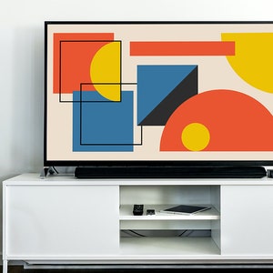 May include: A flat screen television with a geometric abstract design in shades of red, yellow, blue, and black on a cream background.