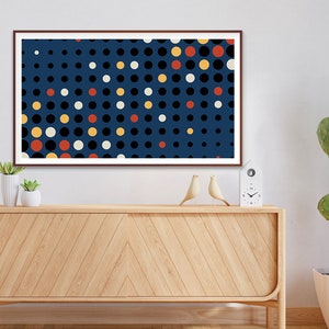 May include: A framed abstract print with a blue background and a pattern of white, black, yellow, and red circles.