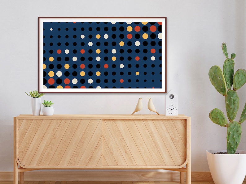 May include: A framed abstract print with a blue background and a pattern of white, black, yellow, and red circles.