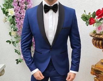 May include: A blue tuxedo suit with a black satin shawl collar and a black bow tie. The suit is made of a smooth fabric and has a classic fit.