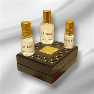Woody creamy sandalwood fragrance oil in clear glass bottle with gold cap for men and women