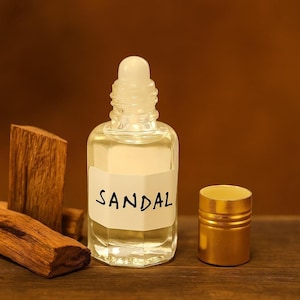 Handmade sandal attar perfume oil, alcohol-free and long-lasting, displayed with sandalwood bark
