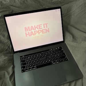 May include: A laptop computer with a motivational quote on the screen that reads "MAKE IT HAPPEN you got this."
