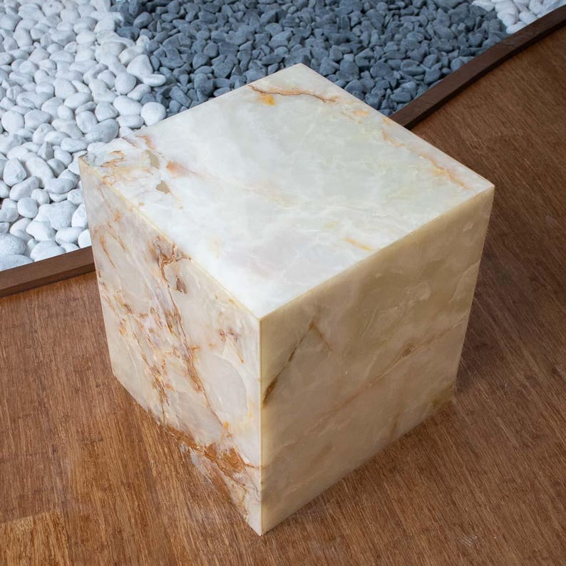 Modern stone coffee table made of white onyx with elegant veining and square silhouette.