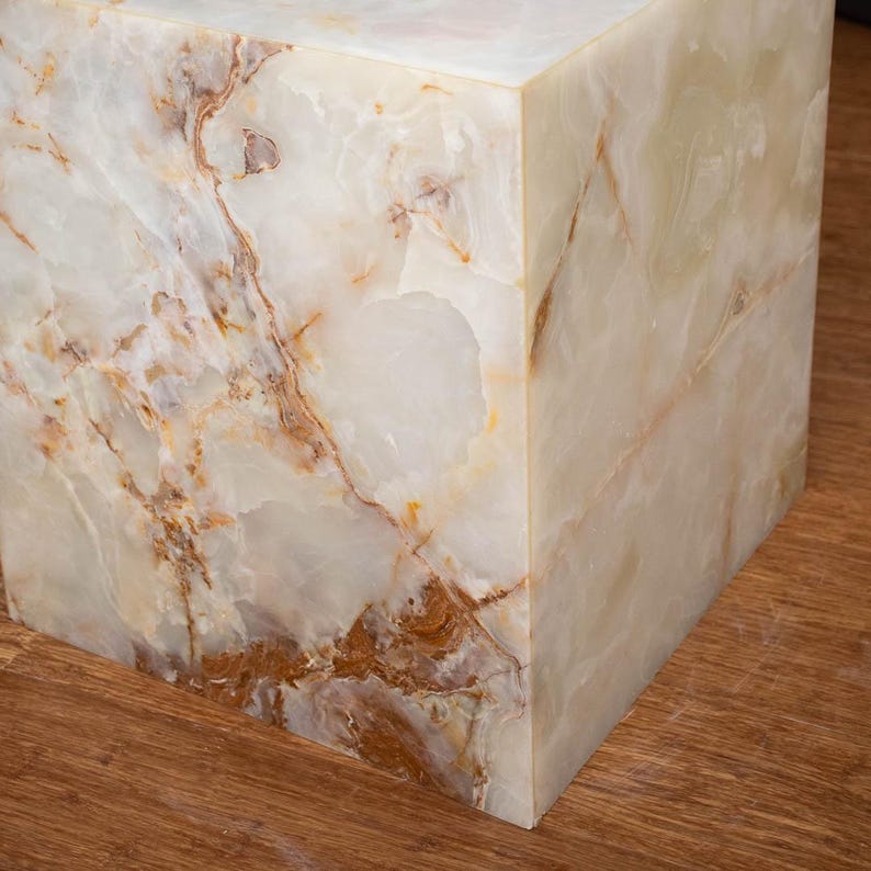 Minimalist white onyx cube table used as a modern accent or side table in home décor.