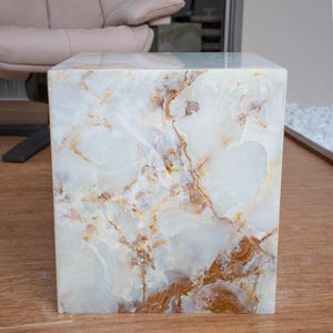 white onyx side table in cube shape featuring polished natural stone texture.