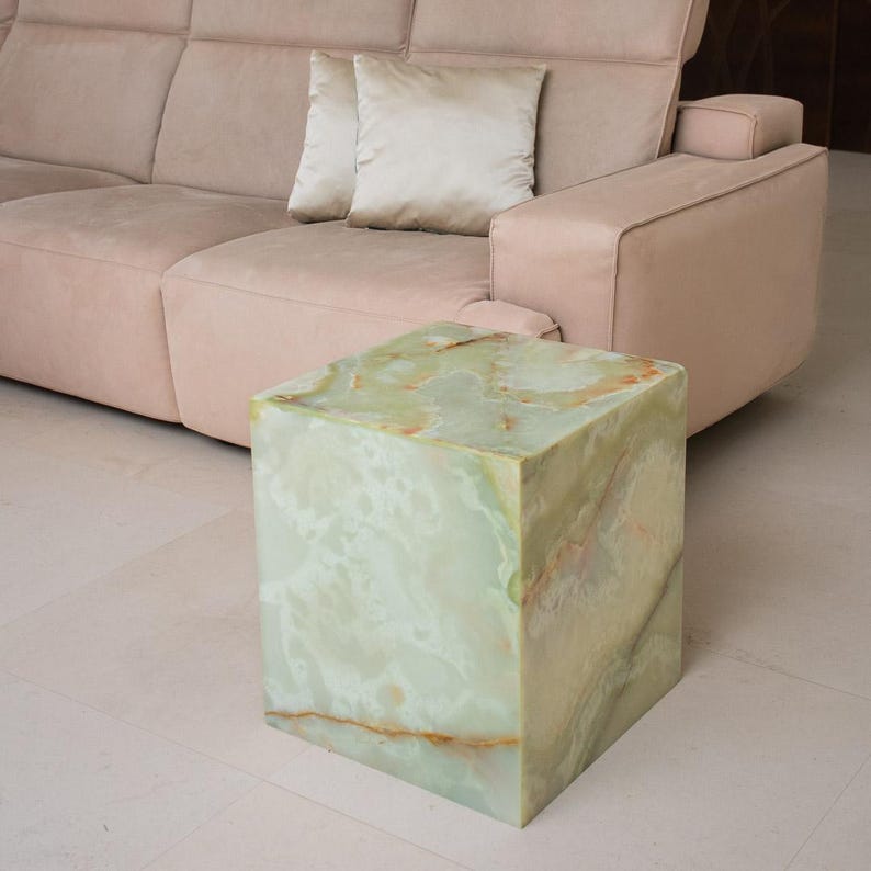 Green onyx end table with a cubic design, perfect for cosy living room spaces