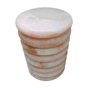 Elegant cocktail table made of solid stone, featuring white onyx and cream marble in a rounded shape