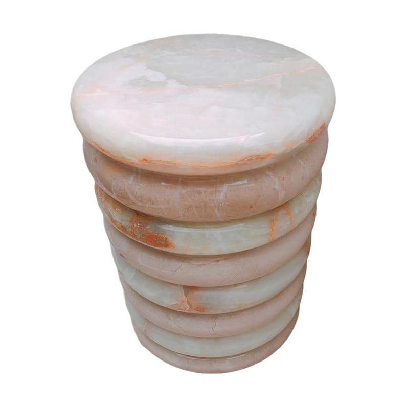 Elegant cocktail table made of solid stone, featuring white onyx and cream marble in a rounded shape