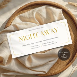 May include: A white gift voucher with gold text that reads "NIGHT AWAY". The voucher is on a wooden tray with a beige cloth. The text includes fields for personalization and the Canva logo.
