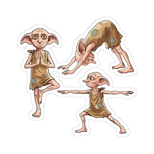 May include: A set of three stickers featuring a small, pale, large-eared creature with big green eyes wearing a tattered tan tunic with patches. The creature is depicted in three different yoga poses: tree pose, downward-facing dog, and warrior pose.