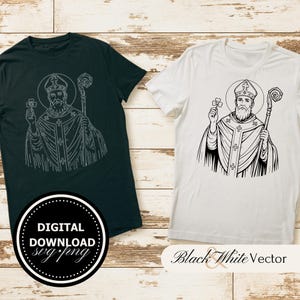 May include: Two t-shirts, one black and one white, each featuring a black and white illustration of Saint Patrick holding a shamrock and staff. The black shirt has a circular "DIGITAL DOWNLOAD svg.png" graphic. The white shirt has "Black & White Vector" text.