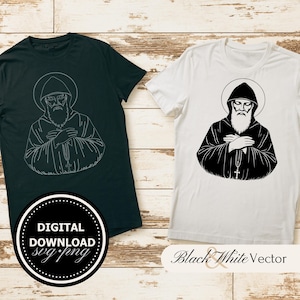 Puede incluir: Dos camisetas, una verde oscuro y otra blanca, cada una con una ilustración en blanco y negro de una figura religiosa con un halo. La camiseta verde oscuro tiene un contorno blanco de la imagen. La camiseta blanca tiene una imagen negra sólida. La camiseta verde oscuro tiene un logotipo de descarga digital.