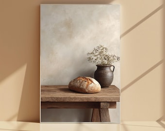 May include: A still life image showing a loaf of bread on a wooden table, alongside a dark brown vase filled with dried flowers. The background is a neutral beige, with shadows adding depth to the scene.