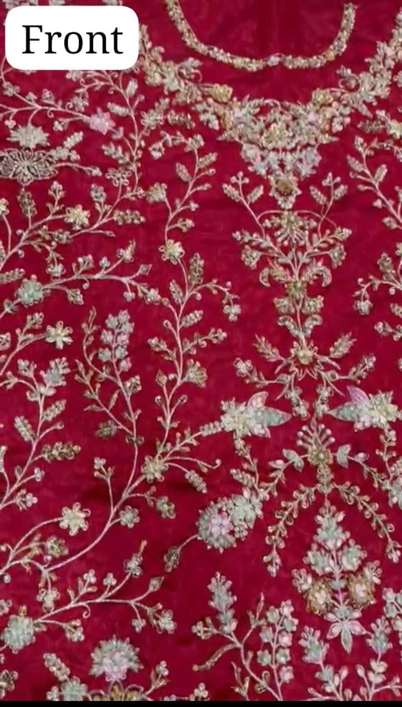 May include: Red fabric with a floral embroidery design. The embroidery is in silver and white thread with small pearl-like beads.