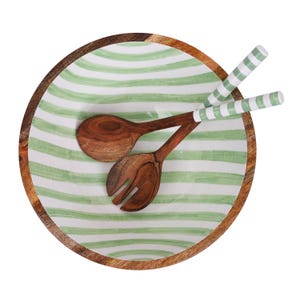May include: A wooden salad bowl with a green and white striped design and a matching wooden salad spoon and fork.