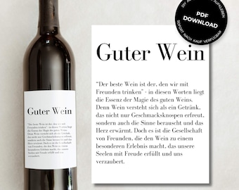 May include: A white card with black text that reads "Guter Wein" and a quote about the magic of wine shared with friends. The card is next to a bottle of red wine with a white label that also reads "Guter Wein".