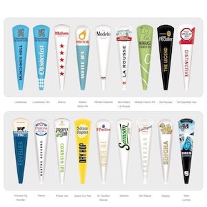 May include: A collection of seventeen tapered beer tap handles arranged in two rows. Each handle features distinct branding, including logos and text for various beer brands such as Lowenbrau, Mahou, Meteor, Modelo, Mont Blanc, Ninkasi, Old Peculier, Old Speckled Hen, Orchard Pig, Peroni, Proper Job, Saison, St. Feuillien, Samson, San Miguel, Singha, and Siren Lumina.